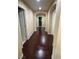 Inviting hallway with dark wood flooring, arched doorways, and neutral paint, creating a seamless flow throughout the home at 6277 Mustang Spring Ave, Las Vegas, NV 89139