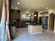 Modern kitchen featuring dark cabinets, a tile backsplash, granite counters, and stainless steel appliances at 6277 Mustang Spring Ave, Las Vegas, NV 89139