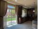 Kitchen with dark wood cabinetry, granite countertops, and a view of the lush backyard at 6277 Mustang Spring Ave, Las Vegas, NV 89139