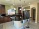 Bright kitchen features a center island, pendant lighting, and modern stainless steel appliances at 6277 Mustang Spring Ave, Las Vegas, NV 89139