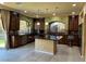 Well-equipped kitchen with dark wood cabinetry, granite countertops, an island, and stainless steel appliances at 6277 Mustang Spring Ave, Las Vegas, NV 89139