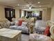 Living room with sofa, chairs, and kitchen view at 6277 Mustang Spring Ave, Las Vegas, NV 89139