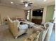 Inviting living room featuring tray ceilings, a ceiling fan, recessed lights, and comfortable seating arrangements at 6277 Mustang Spring Ave, Las Vegas, NV 89139