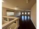 Spacious living room with dark wood flooring, neutral paint, and three large windows providing plenty of natural light at 6277 Mustang Spring Ave, Las Vegas, NV 89139
