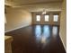 Bright and airy living room featuring dark wood floors, neutral walls, and ample natural light from multiple windows at 6277 Mustang Spring Ave, Las Vegas, NV 89139