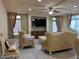 Cozy living room with a modern ceiling fan, recessed lighting, and a green accent wall, perfect for relaxing at 6277 Mustang Spring Ave, Las Vegas, NV 89139