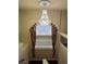 A view looking down the staircase to a large chandelier and decorative window at 6277 Mustang Spring Ave, Las Vegas, NV 89139