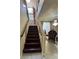 Staircase leading upstairs with wood steps, a chandelier, and neutral-toned walls at 6277 Mustang Spring Ave, Las Vegas, NV 89139