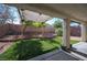 Backyard featuring artificial turf, rock landscaping, privacy wall, and covered patio at 6333 Sterling Ranch Way, North Las Vegas, NV 89081