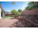 Low-maintenance backyard with rock landscaping, artificial turf, and a brick privacy wall at 6333 Sterling Ranch Way, North Las Vegas, NV 89081