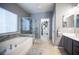 Spacious bathroom featuring a glass enclosed shower, separate tub, and double sinks at 6333 Sterling Ranch Way, North Las Vegas, NV 89081