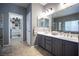Bright bathroom featuring double sinks, modern fixtures and walk-in closet for easy access at 6333 Sterling Ranch Way, North Las Vegas, NV 89081