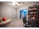 Bedroom featuring carpet flooring, a comfortable armchair, and a bookshelf, ideal for relaxation and reading at 6333 Sterling Ranch Way, North Las Vegas, NV 89081