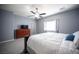 Cozy bedroom with ceiling fan, dresser, carpet, and window providing natural light at 6333 Sterling Ranch Way, North Las Vegas, NV 89081