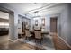 Elegant dining room showcasing a modern light fixture and a classic grandfather clock accenting the space at 6333 Sterling Ranch Way, North Las Vegas, NV 89081