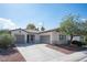 Inviting home with a two-car garage, a well-kept lawn, and desert landscaping under a bright sky at 6333 Sterling Ranch Way, North Las Vegas, NV 89081