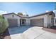 Two-car garage with tile roofing and desert landscaping for easy maintenance under clear blue skies at 6333 Sterling Ranch Way, North Las Vegas, NV 89081