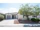 Charming single-story home with a well-maintained front yard and two-car garage on a sunny day at 6333 Sterling Ranch Way, North Las Vegas, NV 89081