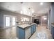 Bright kitchen with granite countertops, stainless steel appliances, and an island sink at 6333 Sterling Ranch Way, North Las Vegas, NV 89081