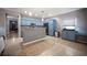 Well-designed kitchen with blue cabinets, stainless steel appliances, and a convenient breakfast bar area at 6333 Sterling Ranch Way, North Las Vegas, NV 89081