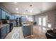 Charming kitchen featuring custom blue cabinetry, stainless steel appliances, and a functional island at 6333 Sterling Ranch Way, North Las Vegas, NV 89081