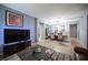 Open-concept living space with a large TV, dining area, and neutral color scheme, perfect for modern living at 6333 Sterling Ranch Way, North Las Vegas, NV 89081