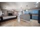 Open layout with a kitchen featuring blue cabinets and a cozy living area with a ceiling fan at 6333 Sterling Ranch Way, North Las Vegas, NV 89081