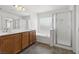 A bathroom with double sinks, a soaking tub, and a walk-in shower at 6636 Surfbird St, North Las Vegas, NV 89084