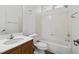 Clean bathroom with white tile, a single sink vanity, and a shower-tub combination at 6636 Surfbird St, North Las Vegas, NV 89084