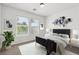 A staged bedroom with simple decor, plants, and plenty of natural light at 6636 Surfbird St, North Las Vegas, NV 89084