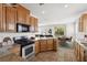 Well-equipped kitchen featuring modern appliances, ample counter space, and an open view of the living areas at 6636 Surfbird St, North Las Vegas, NV 89084