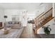 Cozy living space featuring a staircase and views into additional living areas with comfortable furnishings at 6636 Surfbird St, North Las Vegas, NV 89084
