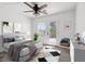 A staged bedroom with a door to the balcony and plenty of natural light at 6636 Surfbird St, North Las Vegas, NV 89084