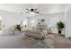 A bedroom with an area rug, a ceiling fan, and plenty of natural light at 6636 Surfbird St, North Las Vegas, NV 89084