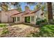 Backyard featuring mature trees, rock landscaping and a patio at 6944 Emerald Springs Ln, Las Vegas, NV 89113
