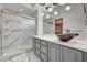 Beautiful bathroom featuring marble floors and a walk in shower with a modern bowl sink at 6944 Emerald Springs Ln, Las Vegas, NV 89113
