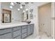 Stylish bathroom featuring gray cabinets, vessel sink, marble countertop and a walk in closet view at 6944 Emerald Springs Ln, Las Vegas, NV 89113