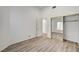 Clean bedroom with vinyl floors, a closet with mirrored doors and a neutral color palette at 6944 Emerald Springs Ln, Las Vegas, NV 89113