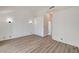 Bright primary bedroom featuring wood floors, neutral paint, vaulted ceilings, and modern light fixtures at 6944 Emerald Springs Ln, Las Vegas, NV 89113