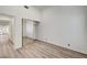 Bright bedroom with vinyl floors, a closet with mirrored doors and a neutral color palette at 6944 Emerald Springs Ln, Las Vegas, NV 89113