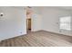 Bright primary bedroom featuring wood floors, neutral paint, vaulted ceilings, and a window view at 6944 Emerald Springs Ln, Las Vegas, NV 89113