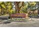 Inviting entrance to 'The Springs' community featuring lush landscaping and a charming stone sign at 6944 Emerald Springs Ln, Las Vegas, NV 89113