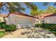 Charming home featuring a tile roof, well-maintained landscaping, and a two-car garage at 6944 Emerald Springs Ln, Las Vegas, NV 89113