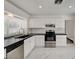 Well-appointed kitchen featuring modern appliances, white cabinets, and sleek countertops at 6944 Emerald Springs Ln, Las Vegas, NV 89113