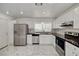 Updated kitchen with stainless steel appliances, white cabinetry, and modern countertops at 6944 Emerald Springs Ln, Las Vegas, NV 89113
