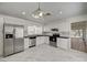 Modern kitchen with stainless steel appliances, white cabinets, black countertops, and marble tile flooring at 6944 Emerald Springs Ln, Las Vegas, NV 89113