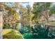Scenic pond view with reflections of trees and nearby homes in the community at 6944 Emerald Springs Ln, Las Vegas, NV 89113