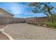 Gravel backyard featuring a grill, bench and desert landscaping at 7528 Golden Yucca Dr, Las Vegas, NV 89147