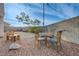 Seating area in the rock-filled backyard, complemented by desert landscaping at 7528 Golden Yucca Dr, Las Vegas, NV 89147