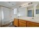 Bathroom features a double sink vanity, large mirror, and shower/tub combo with tiled surround at 7528 Golden Yucca Dr, Las Vegas, NV 89147